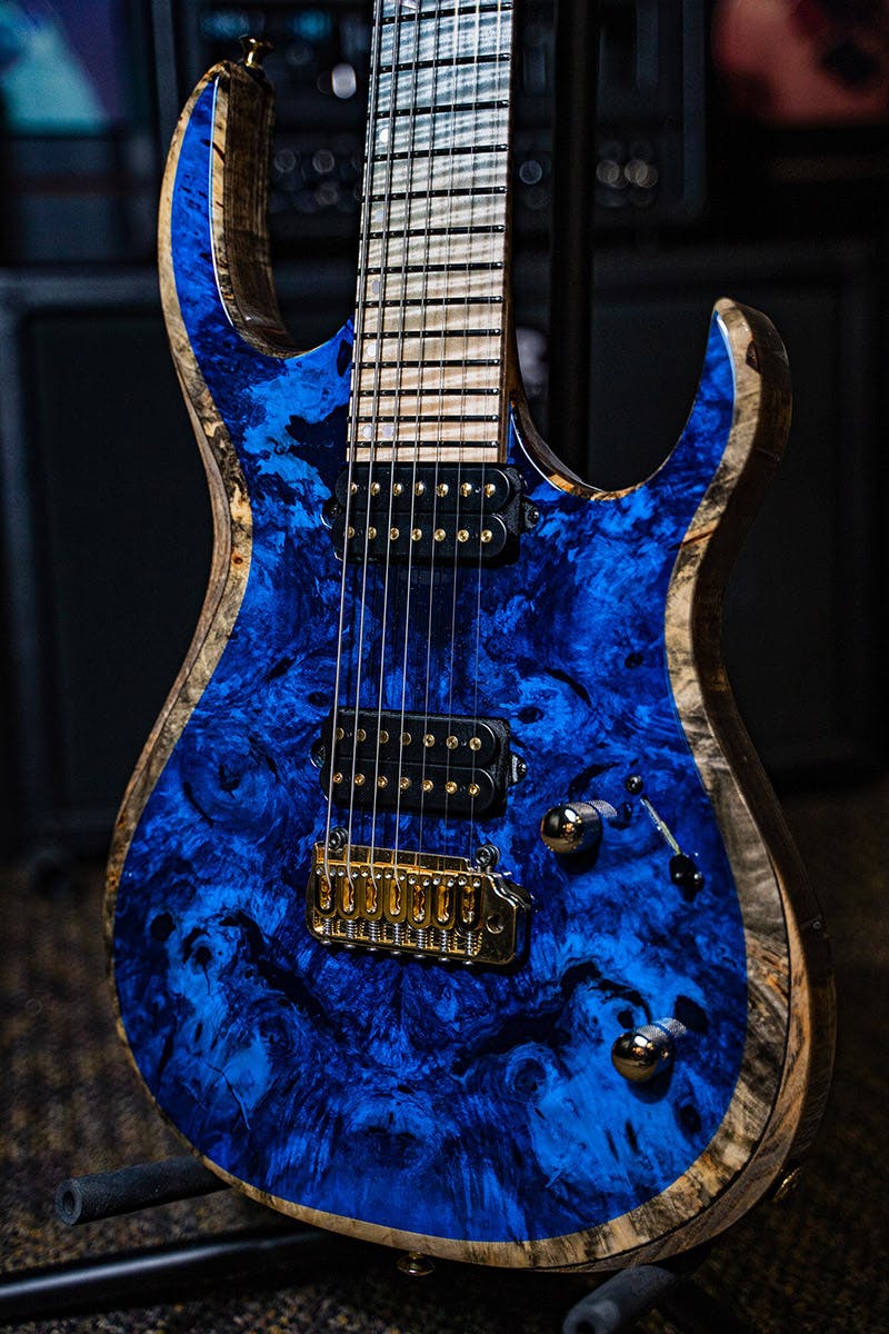 Kiesel Guitars K-Series 7 string tremolo K7X with master grade buckeye burl top, rear natural clear RNC, gold pole pieces, gold hardware, blue finish